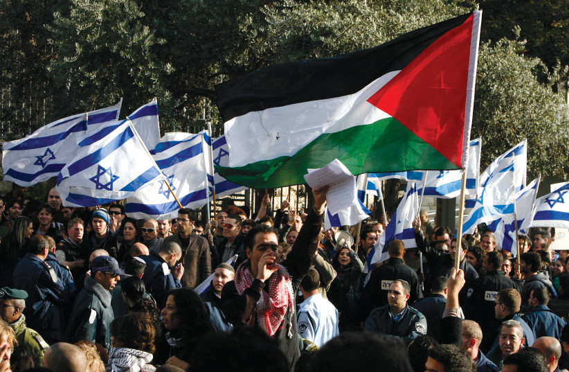 STUDENTS HOLD Palestinian and Israeli flags during a protest at Hebrew University in Jerusalem against Israel’s offensive in Gaza in 2008.  (photo credit: NIKOLA SOLIC/REUTERS)