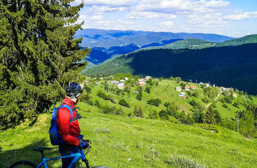  A BIKER stops to admire the view amid the Rhodope mountains. (photo credit: Antonia Chekrakchieva/Unsplash)