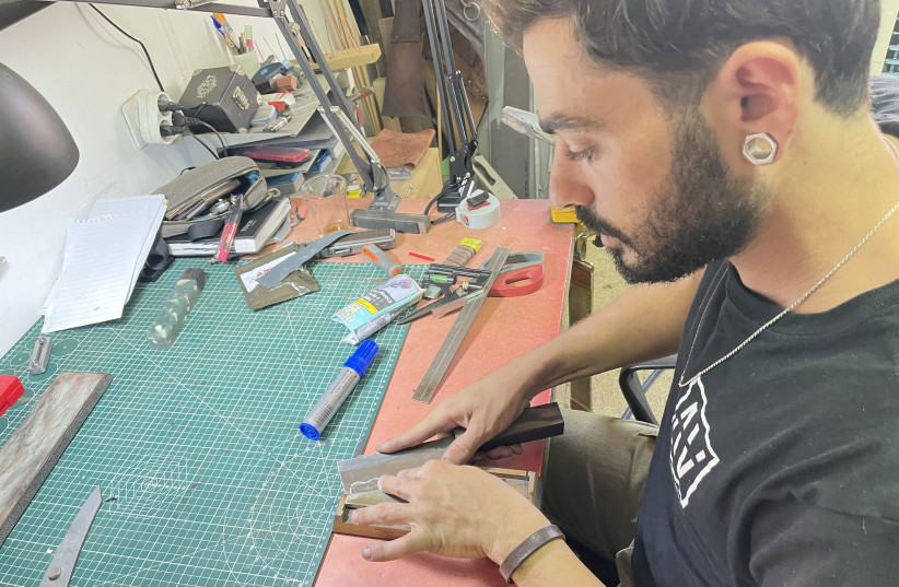  KNIFE MAKER Daniel Nave sharpens a nakiri knife in his studio on Kibbutz Gesher Haziv. (photo credit: Troy O. Fritzhand)