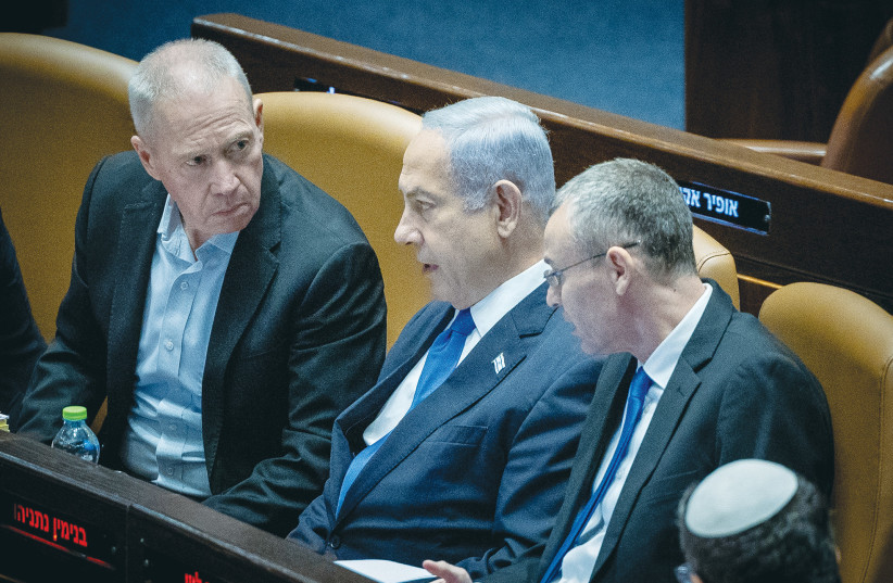  PRIME MINISTER Benjamin Netanyahu confers with Defense Minister Yoav Gallant and Justice Minister Yariv Levin in the Knesset plenum, during voting on the reasonableness legislation last month.  (photo credit: YONATAN SINDEL/FLASH90)