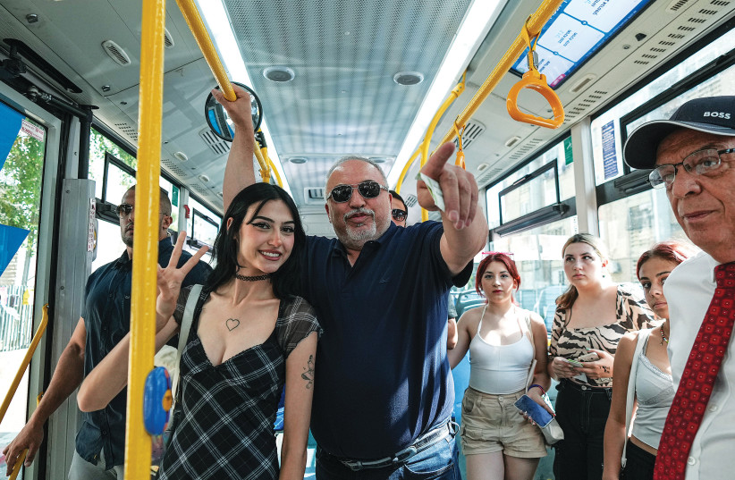  YISRAEL BEYTENU chairman MK Avigdor Liberman rides on a bus in Ashdod on Wednesday, after a recent incident of gender discrimination on a city bus. (photo credit: FLASH90)