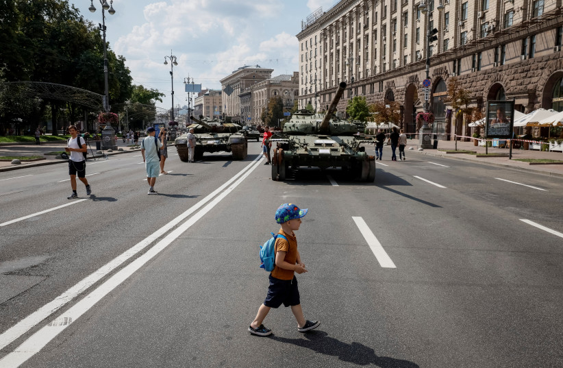 People attend an exhibition displaying destroyed Russian military vehicles located on the main street Khreshchatyk as part of the upcoming celebration of the Independence Day of Ukraine, amid Russia's invasion, in central Kyiv, Ukraine August 21, 2023. (photo credit: GLEB GARANICH/REUTERS)