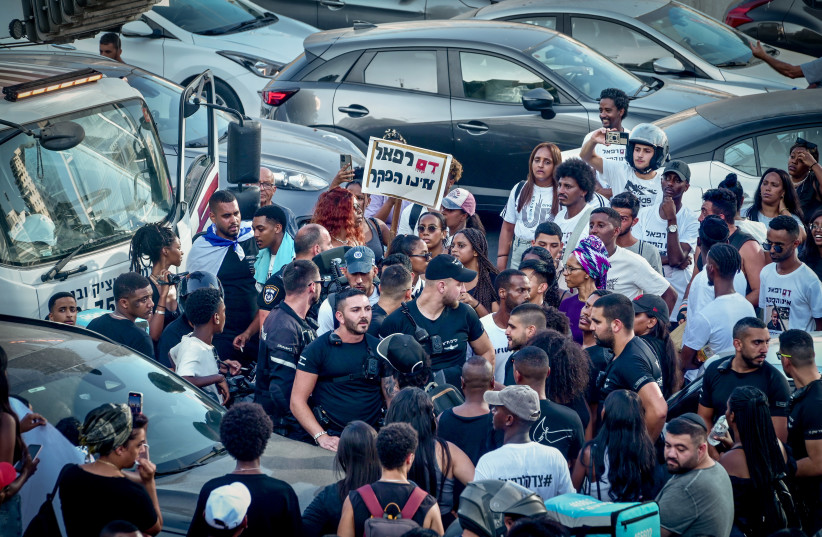  Members of the Jewish Ethiopian community and overs block the Ayalon Highway in Tel Aviv, during a protest demand justice for to 4-year-old Rafael Adana, who was run over and killed in a car accident in Netanya, August 21, 2023.  (photo credit: AVSHALOM SASSONI/FLASH90)