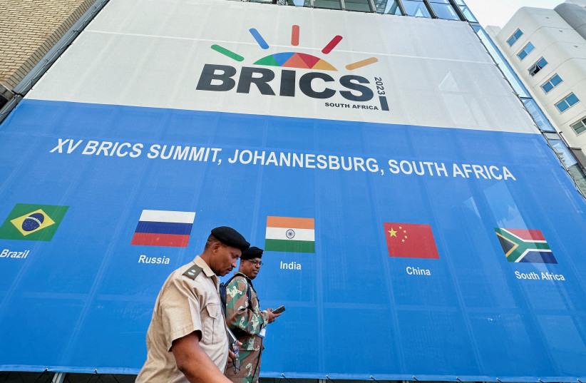  People walk past the Sandton Convention Centre, which will host the upcoming BRICS Summit, in Johannesburg, South Africa August 19, 2023. (photo credit: REUTERS)
