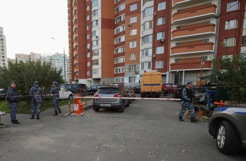  Law enforcement officers secure an area near a multi-storey apartment building, following a reported drone attack in Krasnogorsk, Russia, August 22, 2023 (photo credit: REUTERS/STRINGER)