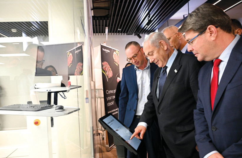  Innovation, Science, and Technology Minister Ofir Akunis (right) accompanies Prime Minister Benjamin Netanyahu on a tour of Steakholder Foods in Rehovot. (photo credit: HAIM ZACH/GPO)