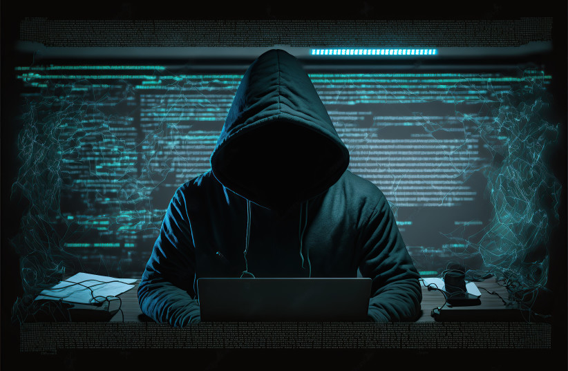 Anonymous hacker with hood and mask sitting next to computer (Illustrative). (photo credit: INGIMAGE)