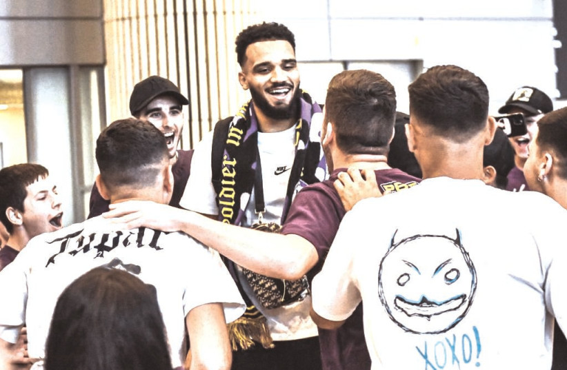 HAPOEL HOLON’S new signee Amine Noua is welcomed by the team’s fans as he arrives in Israel’s Ben-Gurion Airport this week (photo credit: YEHUDA HALICKMAN)