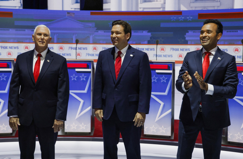 Former U.S. Vice President Mike Pence, Florida Governor Ron DeSantis and businessman Vivek Ramaswamy pose together before the start before the start of the first Republican candidates' debate of the 2024 U.S. presidential campaign in Milwaukee, Wisconsin, U.S. August 23, 2023 (photo credit: REUTERS/JONATHAN ERNST)