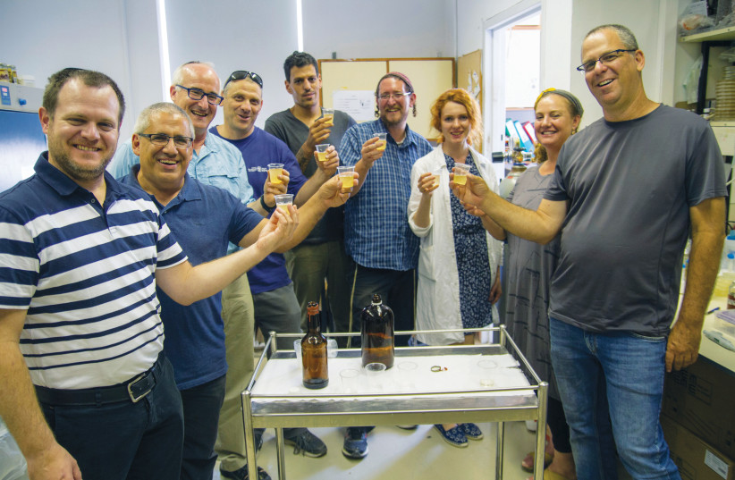 The original team of microbiologists, archaeologists and beer brewers who revitalized, nurtured and brewed beer from the 3,000-year-old yeast strain found in pottery pores at Tel es-Safi (the Philistine city of Gath) (photo credit: YANIV BERMAN/IAA)