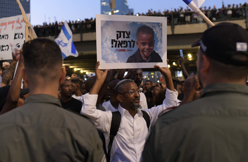  Members of the Ethiopian community and activists block the Ayalon Highway in Tel Aviv during a protest for justice to 4-year-old Rafael Adana, who was run over and killed in a car accident in Netanya, in Tel Aviv, August 23, 2023 (photo credit: TOMER NEUBERG/FLASH90)