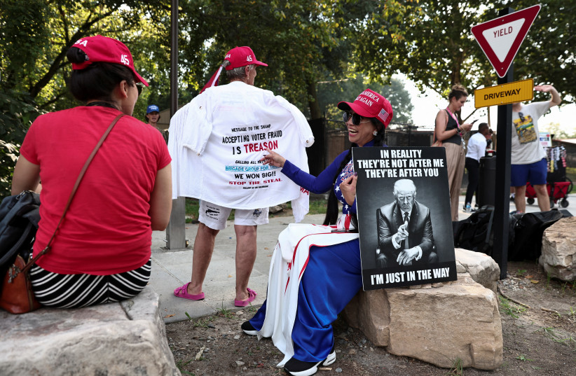Supporters of former US President Donald Trump wait near the entrance of the Fulton County Jail, as Donald Trump is expected to turn himself in to be processed after his Georgia indictment, in Atlanta, Georgia, US, August 24, 2023.  (photo credit: REUTERS/DUSTIN CHAMBERS)