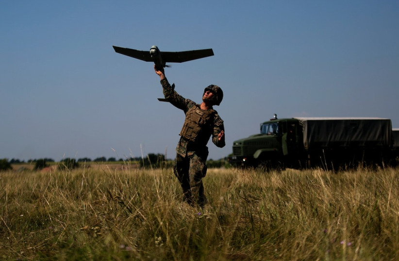  A soldier launches an unmanned aerial drone.. (photo credit: RAWPIXEL)