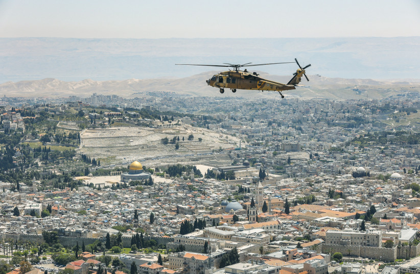  AN AIR FORCE helicopter flies over Jerusalem’s Old City on Independence Day, in April. It’s hard to miss the irony of celebrating 75, when it can be argued that Jews have had a continuous presence here for over 2,000 years, says the writer. (photo credit: FLASH90)