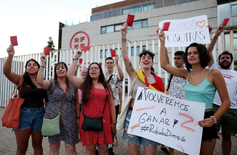  Soccer Football - People protest outside the Spanish Soccer Federation - Ciudad Del Futbol Las Rozas, Las Rozas, Spain - August 25, 2023 People hold banners as they protest against President of the Royal Spanish Football Federation Luis Rubiales. (photo credit: REUTERS/Isabel Infantes)