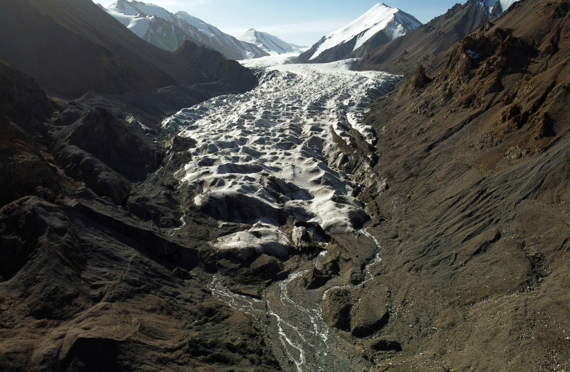  Meltwater from the Laohugou No. 12 glacier, flows though the Qilian mountains, Subei Mongol Autonomous County in Gansu province, China, September 27, 2020 (photo credit: REUTERS/CARLOS GARCIA RAWLINS)