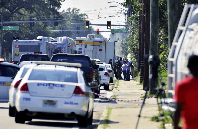 Emergency personnel surround a Dollar General store after a white man armed with a high-powered rifle and a handgun killed three Black people before shooting himself, in what local law enforcement described as a racially motivated crime in Jacksonville, Florida, US. August 26, 2023 (photo credit: Bob Self/USA Today Network via REUTERS)