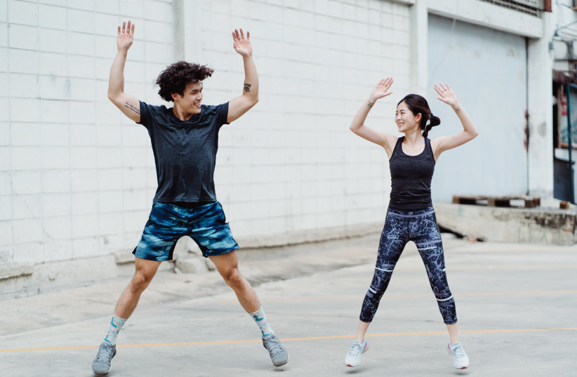  A man and woman exercise together. (photo credit: PEXELS)