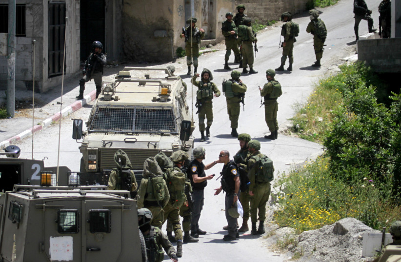  Israeli soldiers detain Palestinians in the village of Yabad, near the West Bank city of Jenin on May 12, 2020 (photo credit: NASSER ISHTAYEH/FLASH90)