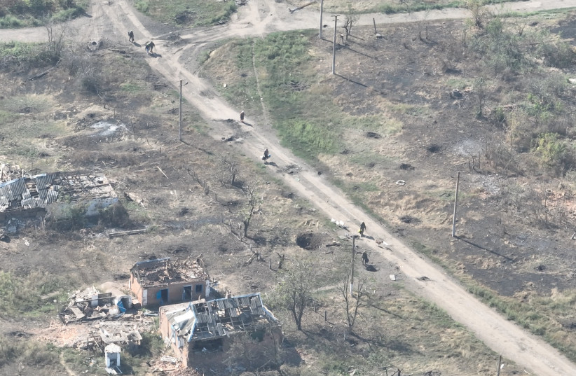  Ukrainian soldiers of the Separate Assault Battalion 'Skala' enter the embattled village of Robotyne, Zaporizhzhia region, Ukraine, in this screengrab taken from a handout video released on August 25, 2023. (photo credit: Separate Assault Battalion 'Skala' of the Ukrainian Armed Forces/Handout via REUTERS)