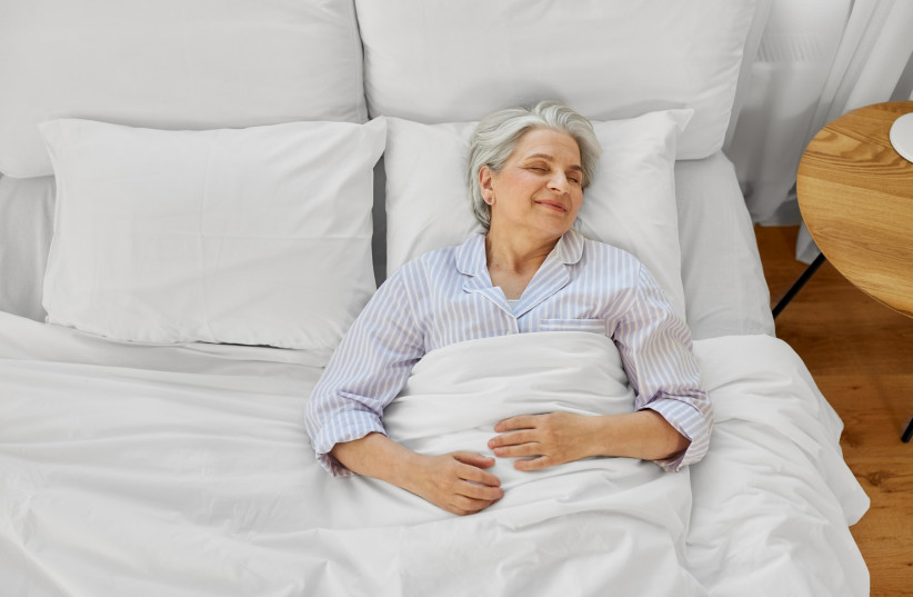  An older woman is seen sleeping in bed (illustrative). (photo credit: INGIMAGE)
