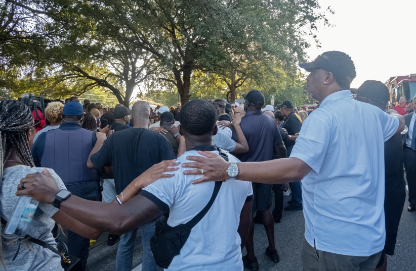  Mourners attend a prayer vigil a day after a white man armed with a high-powered rifle and a handgun killed three Black people at a Dollar General store in Jacksonville, Florida, U.S. August 27, 2023. (photo credit: REUTERS/Malcolm Jackson)