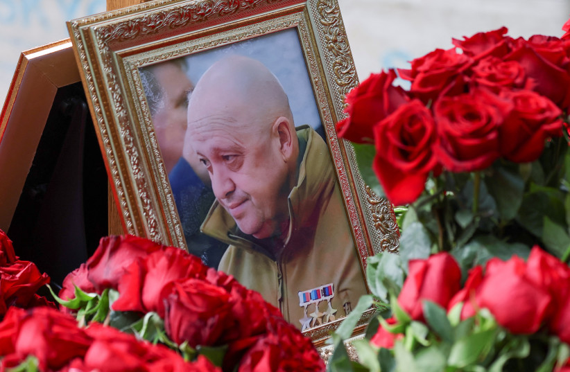  A view shows a framed photo of Russian mercenary chief Yevgeny Prigozhin at his grave at the Porokhovskoye cemetery in Saint Petersburg, Russia, August 30, 2023.  (photo credit: REUTERS/STRINGER)