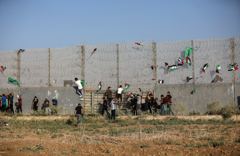  Palestinian demonstrators protest at the Israel-Gaza border fence, east of Gaza City August 21, 2023. (photo credit: ATIA MOHAMMED/FLASH90)