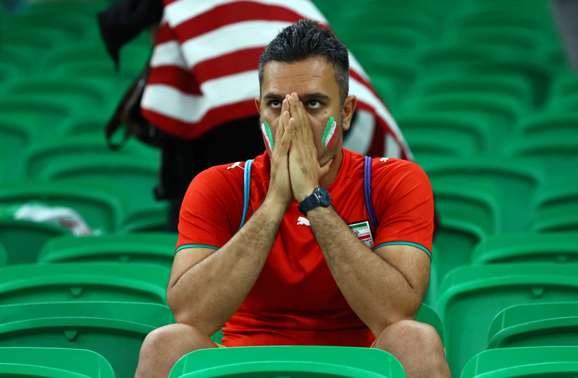   Iran fan looks dejected in the stands after being eliminated from the World Cup (photo credit: Wolfgang Rattay/Reuters)