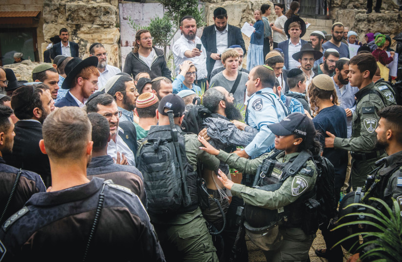  JEWISH ACTIVISTS clash with police during a protest against a Christian conference, outside the Davidson Center in Jerusalem’s Old City, May 28. (photo credit: Arie Leib Abrams/Flash90)
