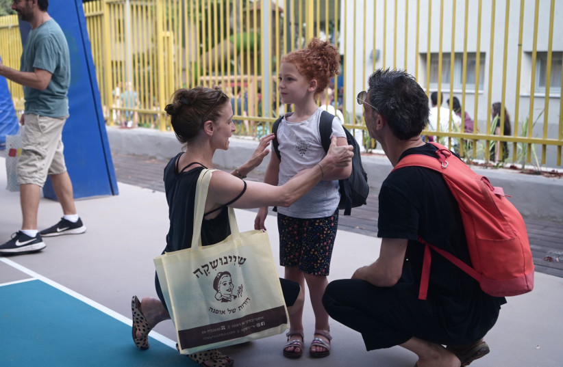  Parents prepare their child for the first day of school in Israel, on September 1, 2023.  (photo credit: AVSHALOM SASSONI/MAARIV)