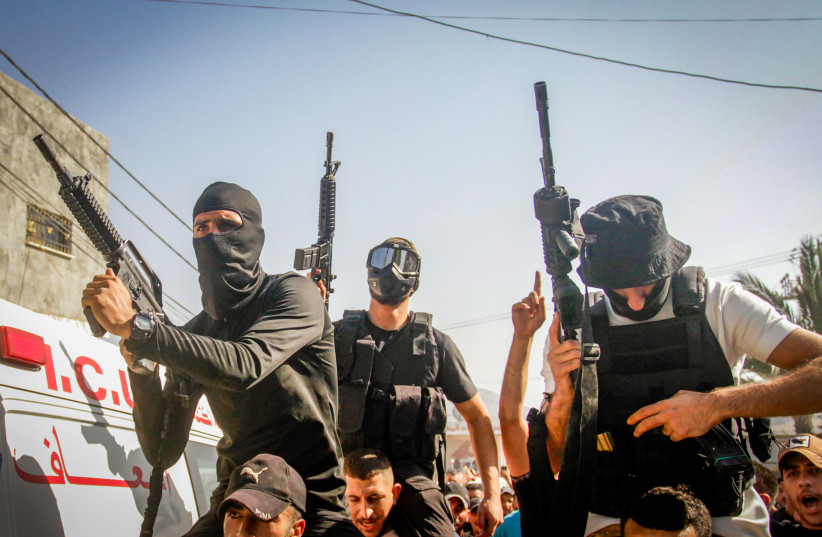 Palestinian gunmen march after an Israeli military raid in the Palestinian village of Aqaba, in the West Bank, September 1, 2023 (photo credit: NASSER ISHTAYEH/FLASH90)