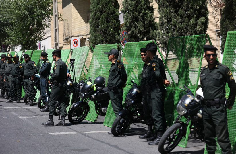 Police stand guard outside the Swedish Embassy during a protest against a man who burned a copy of the Quran outside a mosque in the Swedish capital Stockholm, in Tehran, Iran June 30, 2023.  (photo credit: MAJID ASGARIPOUR/WANA/REUTERS)