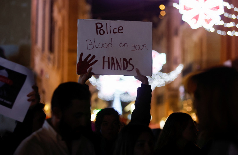  People take part in a protest marking International Day for the Elimination of Violence against Women, after allegations that a lack of prompt action by authorities led to a case of femicide, in Valletta, Malta November 25, 2022.  (photo credit: DARRIN ZAMMIT LUPI/REUTERS)