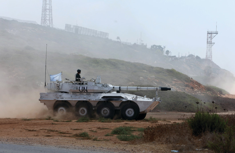  A UNIFIL peacekeeper rides on an armored vehicle in Naqoura, near the border with Israel, in southern Lebanon, on August 31, the day of the UN Security Council’s decision to extend the force’s mandate.  (photo credit: AZIZ TAHER/REUTERS)