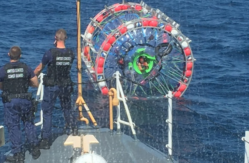   U.S. Coast Guard crews stopped Reza Baluchi (seen sticking his head out of his bubble craft) during his journey from Florida to Bermuda on Sunday, April 25th, 2016. (photo credit: VIA WIKIMEDIA COMMONS)