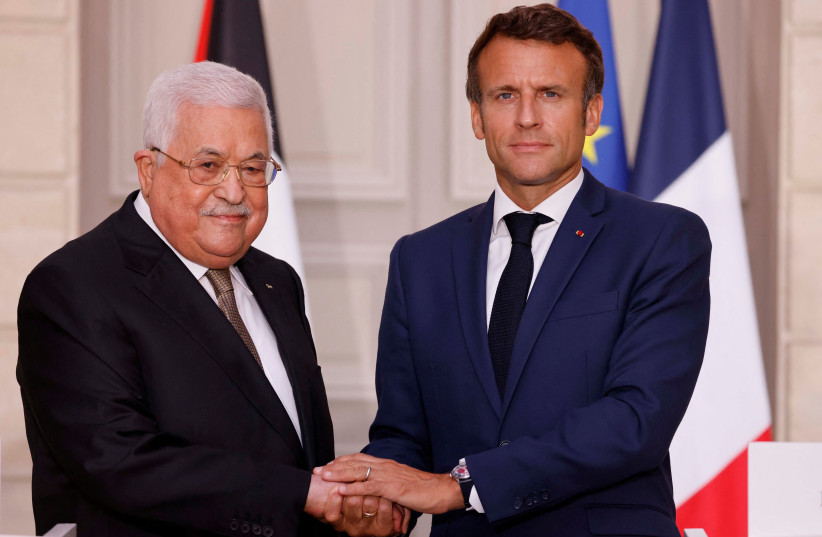  French President Emmanuel Macron welcomes Palestinian President Mahmoud Abbas before a meeting at the Elysee Presidential Palace in Paris, France July 20, 2022 (photo credit: LUDOVIC MARIN/POOL VIA REUTERS)