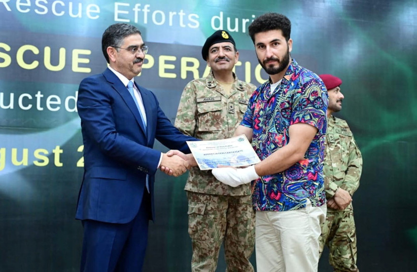  Pakistan's caretaker Prime Minister Anwaar-ul-Haq Kakar awards appreciation certificate to rescuer Mohammad Ali, zipline rescuer of Battagram chairlift incident, during a ceremony at Prime Minister House in Islamabad, Pakistan, August 24, 2023. (photo credit: Press Information Department (PID)/Handout via REUTERS)