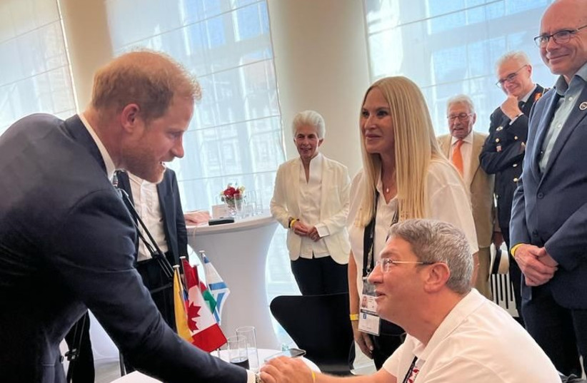   Idan Kaliman, who leads the delegation and also chairs the Disabled Veterans IDF Organization, speaking with Prince Harry in Dusseldorf, Germany. (photo credit: Disabled Veterans IDF Organization)