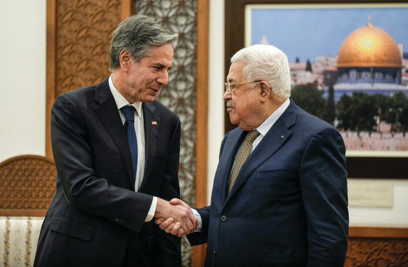  US Secretary of State Antony Blinken shakes hands with Palestinian Authority head Mahmoud Abbas in Ramallah, earlier this year. The Biden administration should stop paying the PA’s bills, says the writer.  (photo credit: MAJDI MOHAMMED/REUTERS)