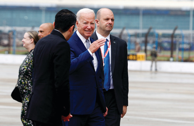President Joe Biden speaks to a staff member at Indira Gandhi International Airport in New Delhi on Sunday, before his departure following the G20 Summit. (photo credit: EVELYN HOCKSTEIN/REUTERS)