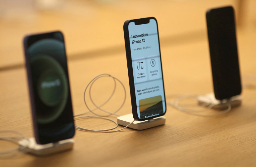  iPhone 12s are seen at the new Apple Store on Broadway in downtown Los Angeles, California, US, June 24, 2021 (photo credit: REUTERS/LUCY NICHOLSON)