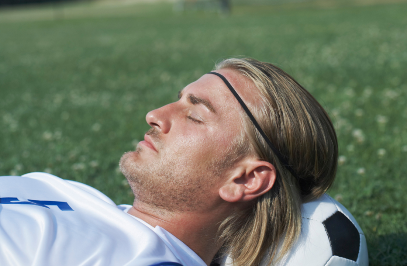  Surprisingly, neither his teammates nor the team's staff noticed the absence of their captain. Soccer player sleeping (illustration) (photo credit: THINKSTOCK)
