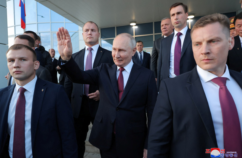 Russia's President Vladimir Putin waves as he meets with North Korean leader Kim Jong Un (not pictured) in Russia, September 13, 2023 (photo credit: KCNA VIA REUTERS)