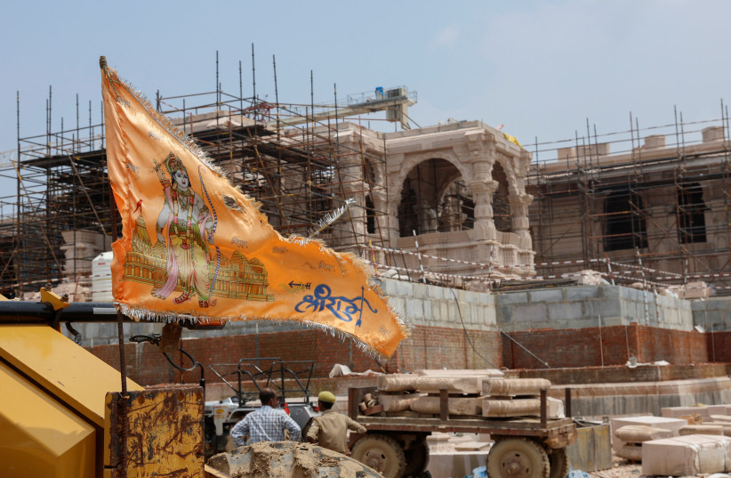  A religious flag is seen in front of the under-construction Hindu Ram Temple in Ayodhya in India, July 9, 2023. (photo credit: REUTERS/ADNAN ABIDI)
