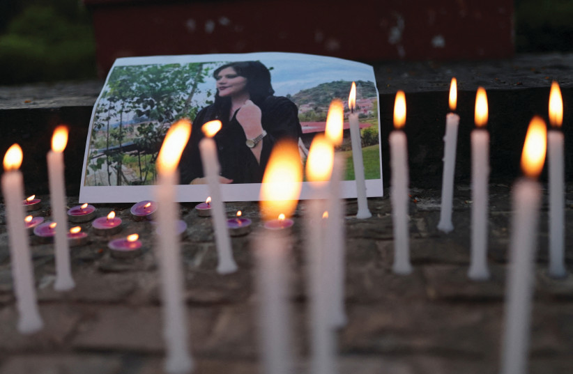  A PHOTO OF Mahsa Amini is pictured at a vigil of faculty students and activists from Delhi University in New Delhi, India, last September following her death. (describe credit: REUTERS/ANUSHREE FADNAVIS)
