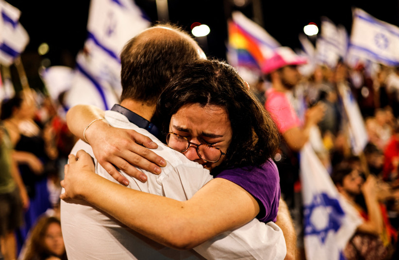  PROTESTERS HUG during an anti-judicial reform protest near the Knesset, in July.  (photo credit: AMIR COHEN/THE JERUSALEM POST)