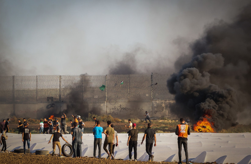  Palestinian demonstrators clash with Israeli soldiers at the Israel-Gaza border fence, east of Gaza City September 15, 2023 (photo credit: ATIA MOHAMMED/FLASH90)
