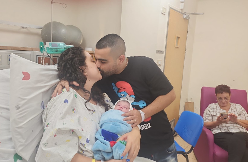  The Sarusi family is seen holding their newborn, the first Israeli child born in the Jewish New Year 5784 (photo credit: COURTESY OF WOLFSON MEDICAL CENTER)