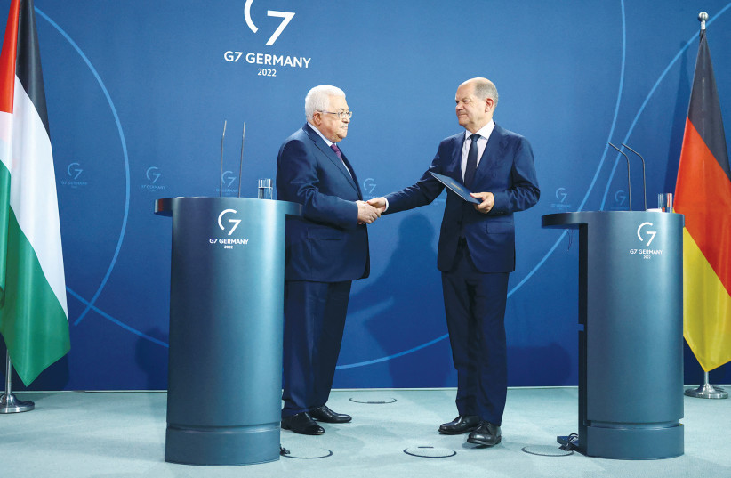  GERMAN CHANCELLOR Olaf Scholz and PA head Mahmoud Abbas shake hands at a news conference, in Berlin, last year. At the news conference, Abbas claimed that the Palestinian people had faced ‘50 holocausts.’ (photo credit: Lisi Niesner/Reuters)